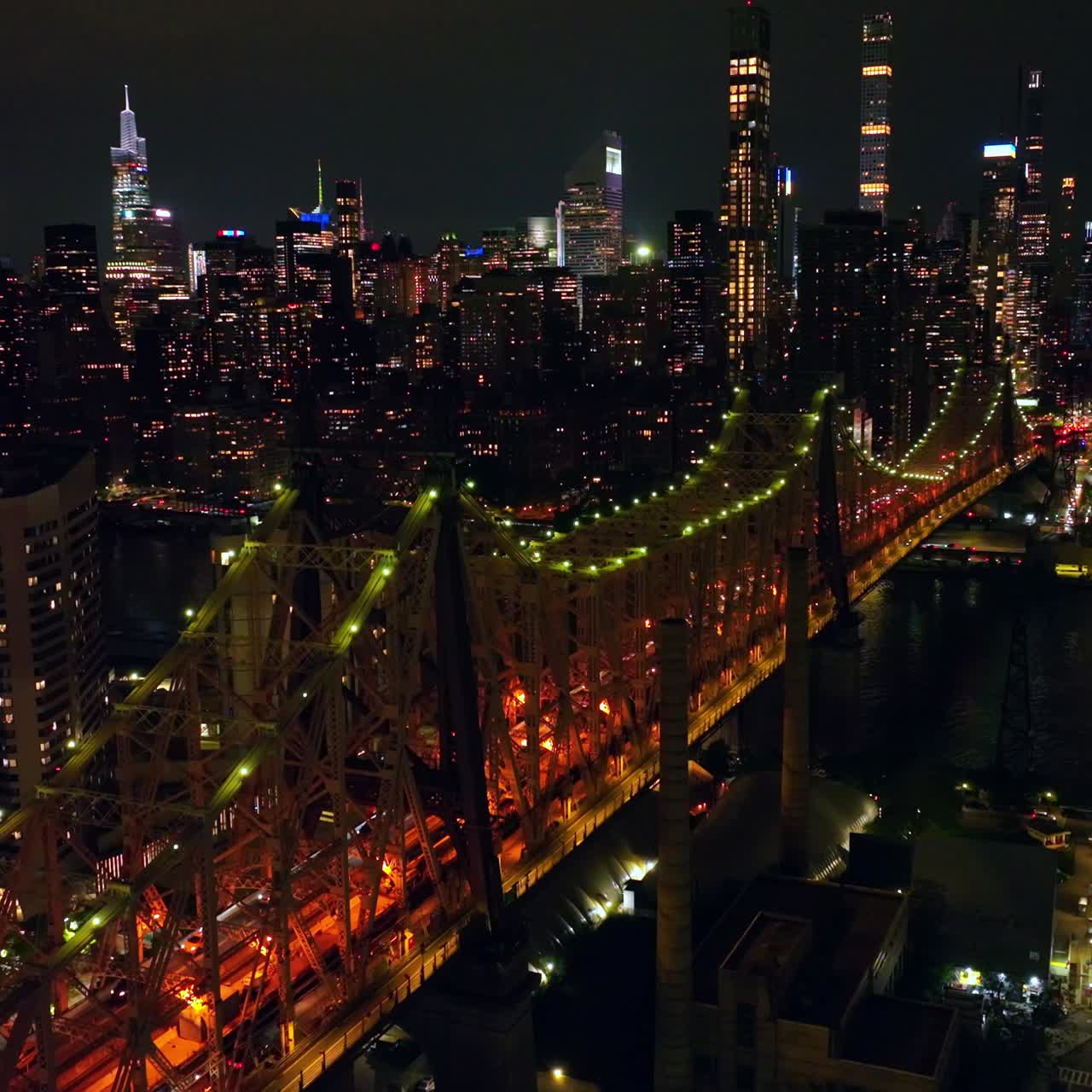 Ed Koch Queensboro Bridge with splendid backlight at night. Stunning panorama of New York City skyscrapers shining bright