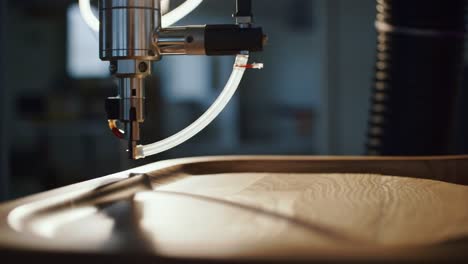 close-up of an automated woodworking machine engaging in precision crafting with a laser tool on a smooth wooden surface in a modern workshop environment