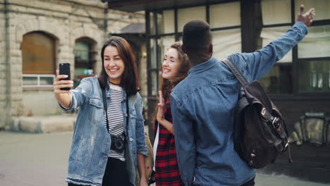 friends taking selfie in city