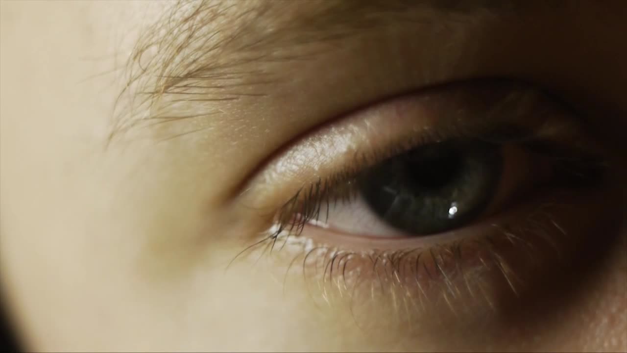 Human eye opens, then wonders around. Thinking. Laughing, talking.