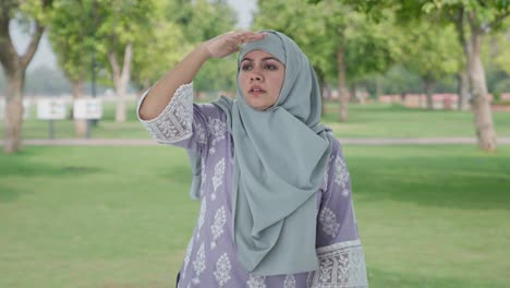 confused muslim woman looking here and there in park