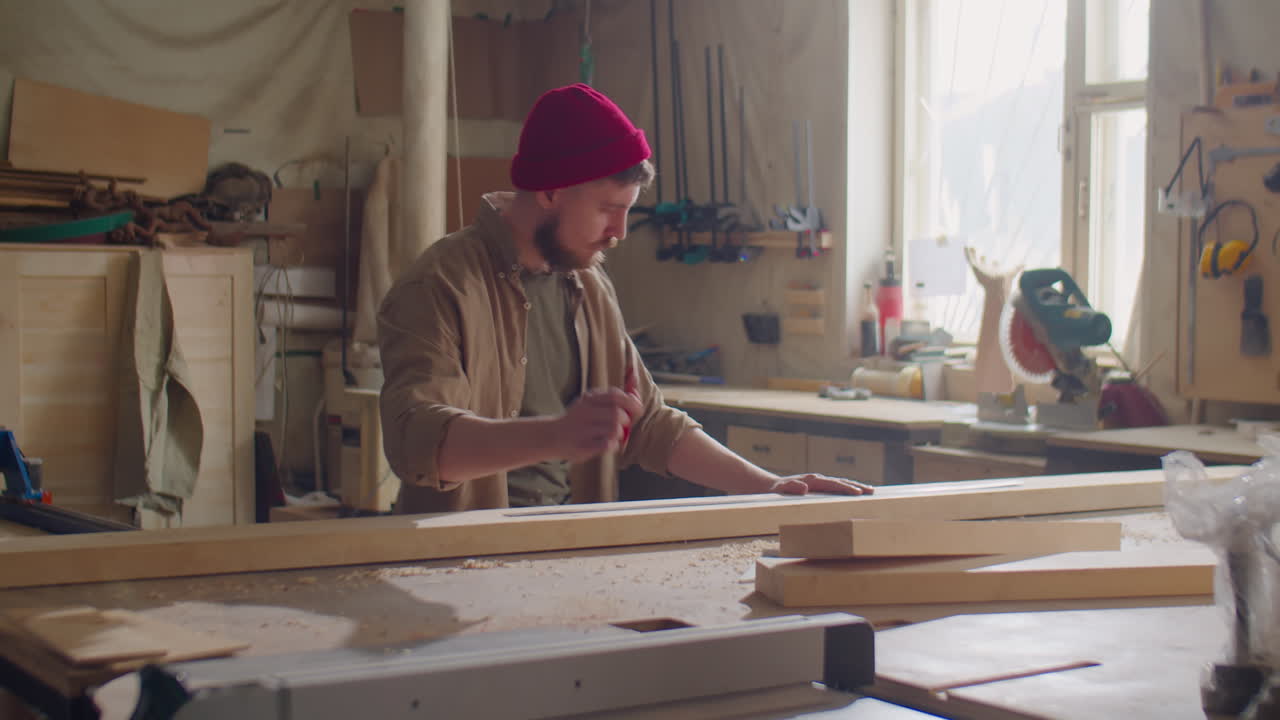 Carpenter Using Ruler and Pencil while Working with Wooden Plank