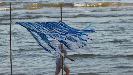 fabric art installation fluttering by the sea.