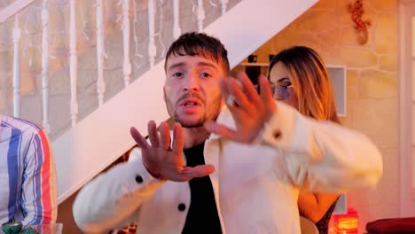 close-up shot of a musician performing in a house with backup dancers
