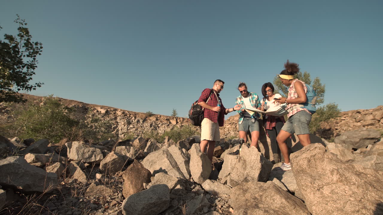 A group of people hiking outdoors with a map