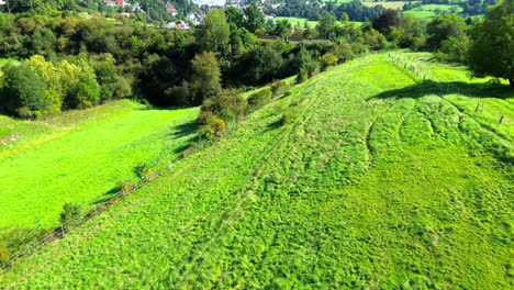 aerial-view-of-green-meadows-and-rolling-hills-4k