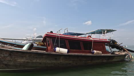 person navigating a wooden boat on a serene lake