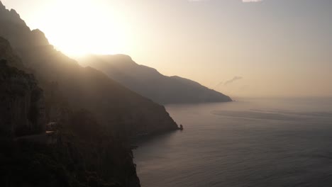 Drone-flying-over-the-Amalfi-coastline-in-the-early-morning-sunrise-in-Italy-in-4k