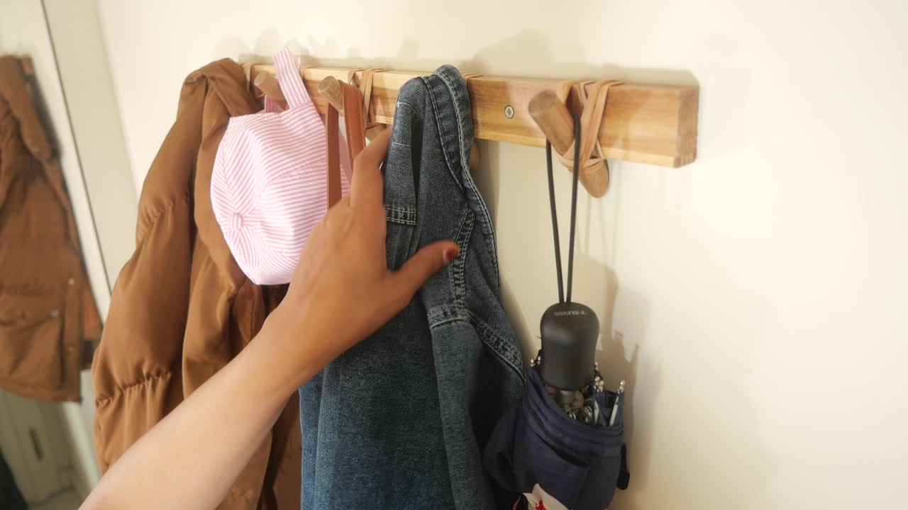 Clothes and umbrella on a wall hanger