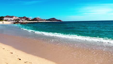 Still-shot-of-the-Cabo-San-Lucas-beach-with-very-calm-water-blue-sky-almost-no-clouds-and-no-waves