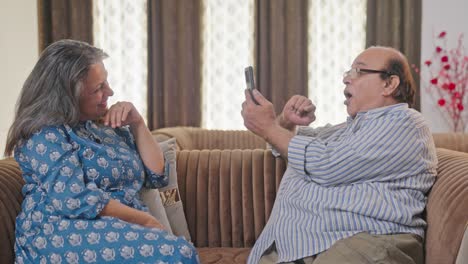 happy indian couple clicking pictures