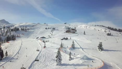 4k drone flying over a busy snowy slope in the french alps, flachau, austria