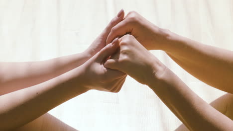 Senior-Woman-And-Female-Doctor-Holding-Hands