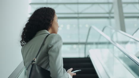 Phone,-escalator-and-travel-with-business-woman