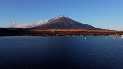 majestic mount fuji with a clear blue sky reflected in the calm lake waters at dusk