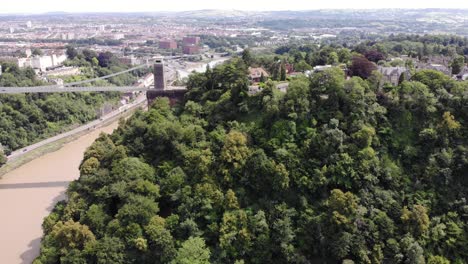 aerial pan left above leigh woods with reveal of clifton suspension bridge