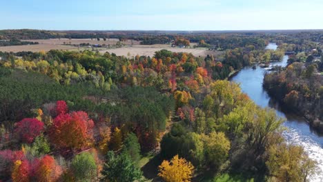 beautiful michigan river and fall colors captured from an aerial view moving forward panning slowly.