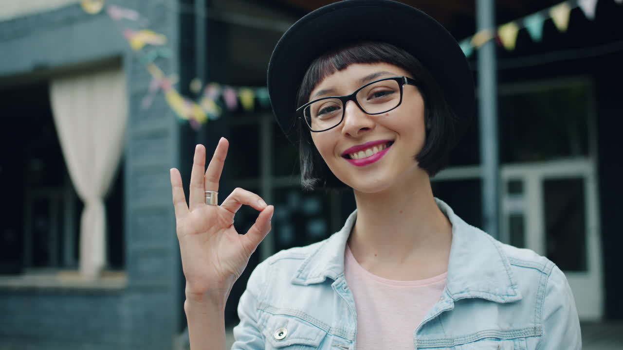 Woman Outdoors with OK Gesture