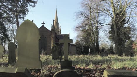 rural english woodland village church hidden by trees in countryside sunrise sunlight