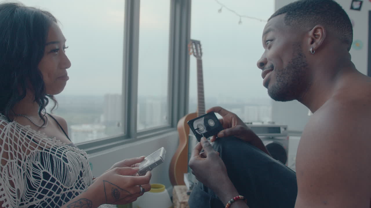 Young Boyfriend and Girlfriend Discussing Old Cassette Tapes