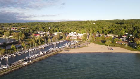 sandy beach near private boats dock in suttons bay, aerial drone view