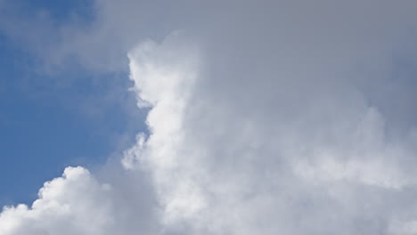 Vivid-blue-sky-with-puffy-white-cumulus-clouds,-ideal-for-weather-and-nature-themes