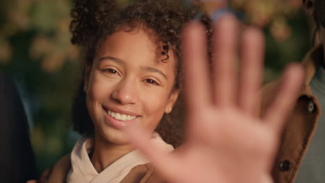 portrait girl stretching hand looking camera in golden sunlight. dreamy cute kid