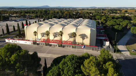 Aerial-view-of-a-distinctive-modern-building-with-a-wavy-roof-structure