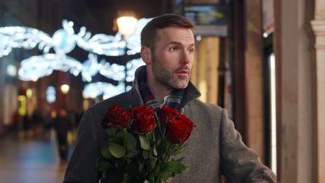 worried man with bunch of roses waiting for his lady