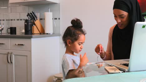 young mother giving food to her daughter on dining table 4k