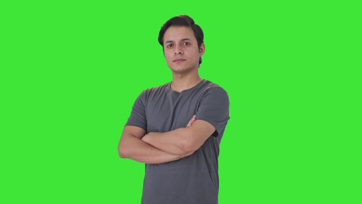 retrato de un hombre indio confiado de pie con las manos cruzadas pantalla verde