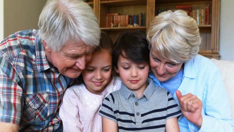 grandparents and grandchildren having fun together in living room