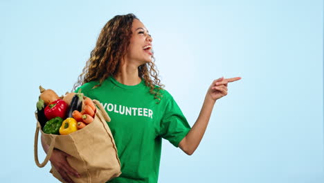 Volunteer-woman,-point-and-smile-in-studio