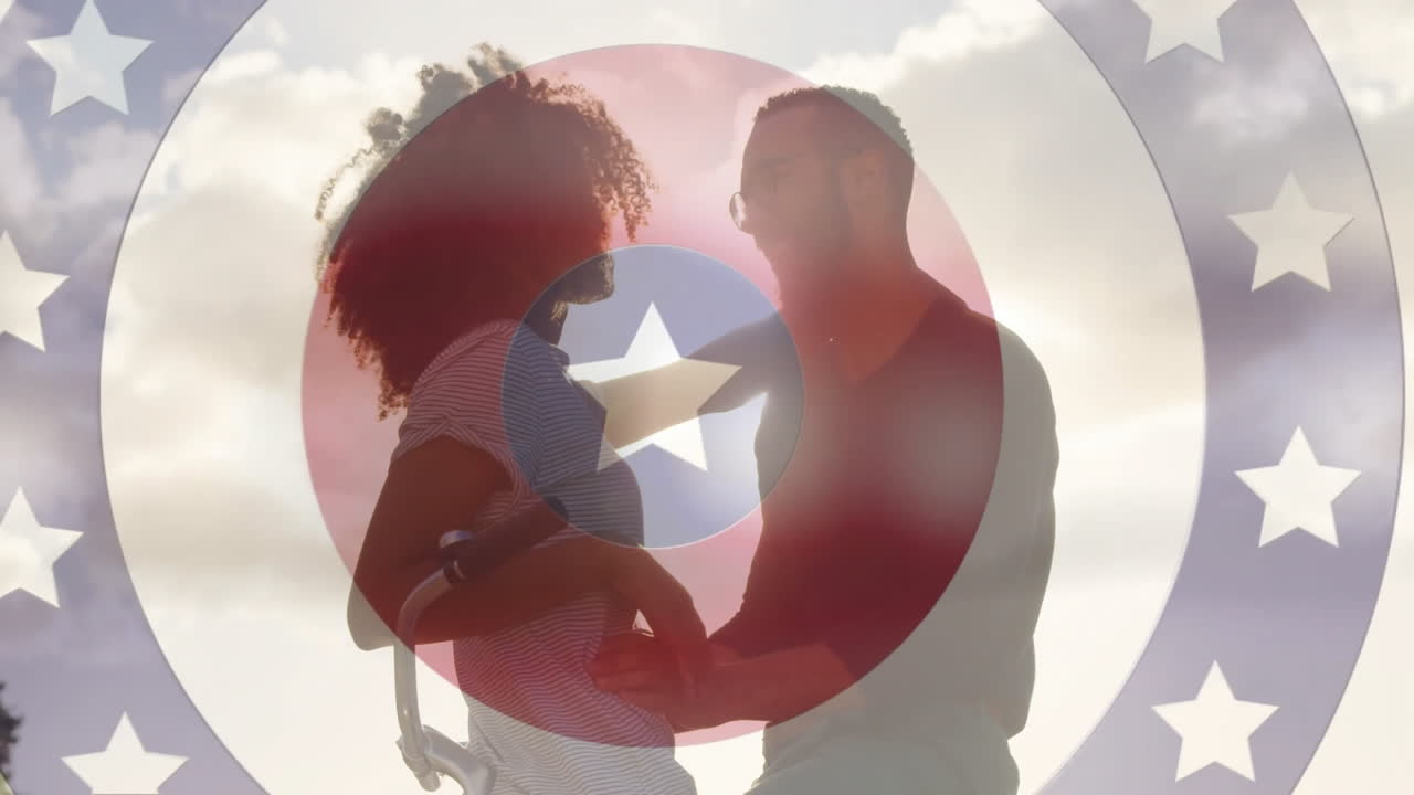 Embracing on bicycle, couple with patriotic star and stripes animation overlay