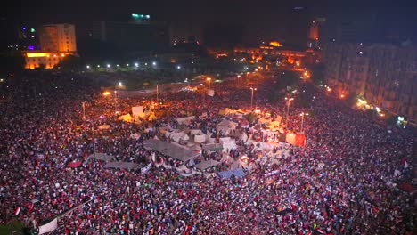 view overlooking an enormous nighttime rally in tahrir square in cairo egypt