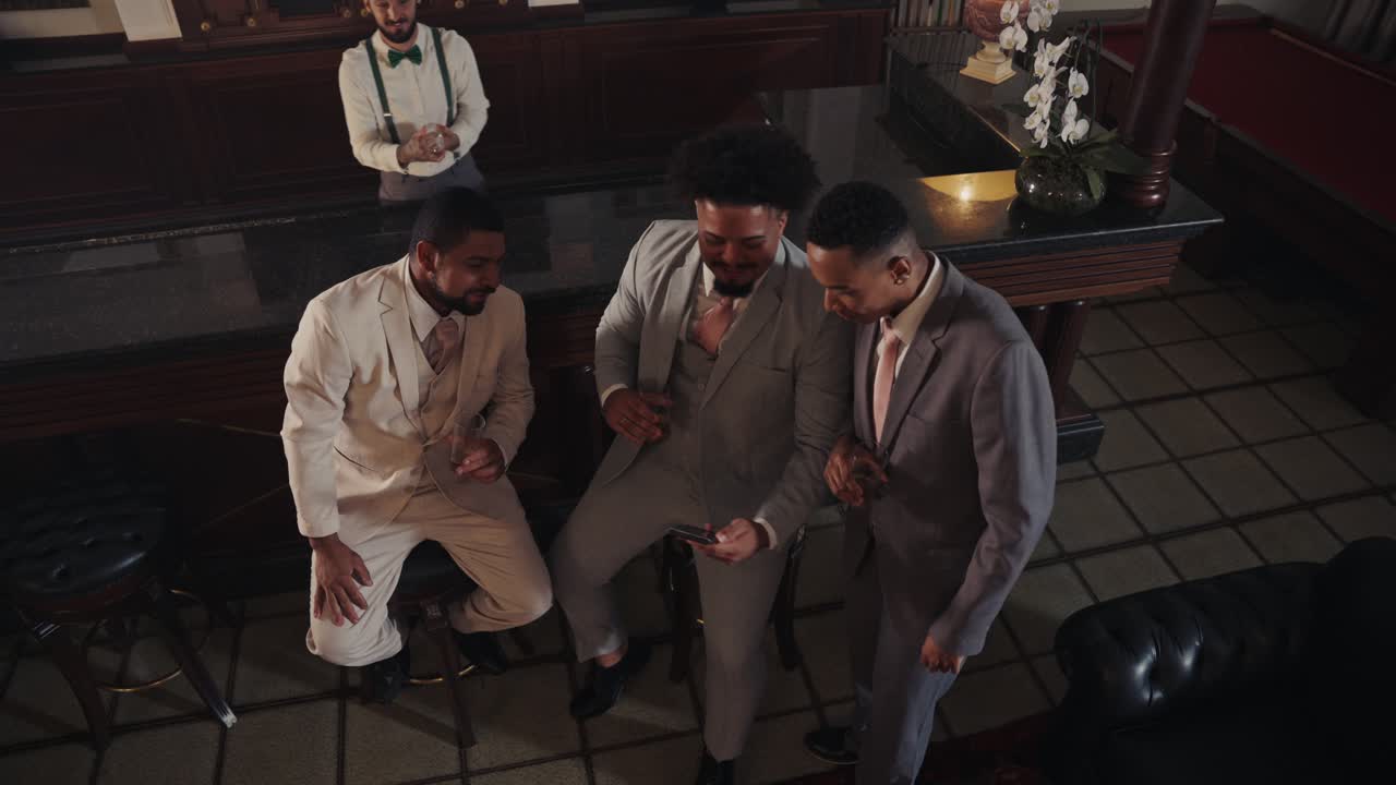 Group of Elegant Men Socializing and Interacting in a Sophisticated Bar