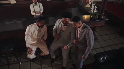 group of elegant men socializing and interacting in a sophisticated bar