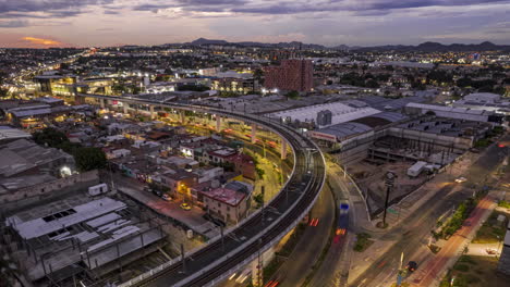 A-mesmerizing-hyperlapse-showcasing-the-bustling-cityscape-of-Zapopan-and-Guadalajara,-featuring-the-Light-Rail-Transit-System-and-a-stunning-sunset