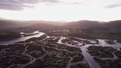 aerial 4k view of coastal ria, tidal low valley mudbanks at dusk spain