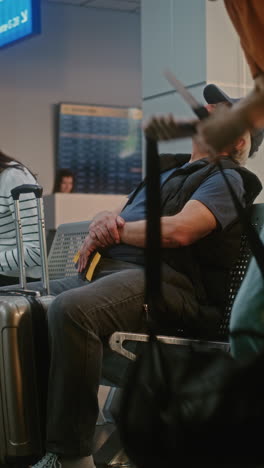 senior man sleeping in airport