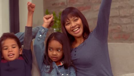 Smiling-Hispanic-family-put-their-hands-up