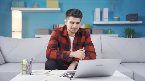 Young-man-reading-messages,-mail,-news-from-laptop,-nods-his-head-positively.