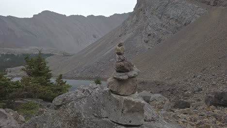 cairn rock close up hikers in the background approached rockies kananaskis alberta canada