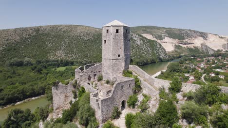 Aerial-rising-castle-ruins-citadel-Počitelj-in-the-Balkans-on-a-sunny-summer-day