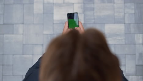 Confident-businessman-hands-holding-smartphone-text-closeup.-Chroma-key-screen.