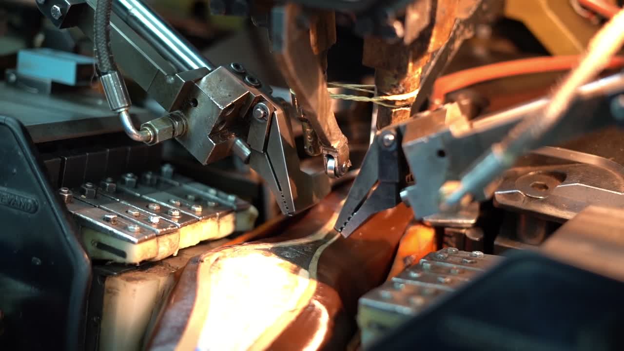 a craftsman handmade a shoe by a machine, close up shot, insert shot