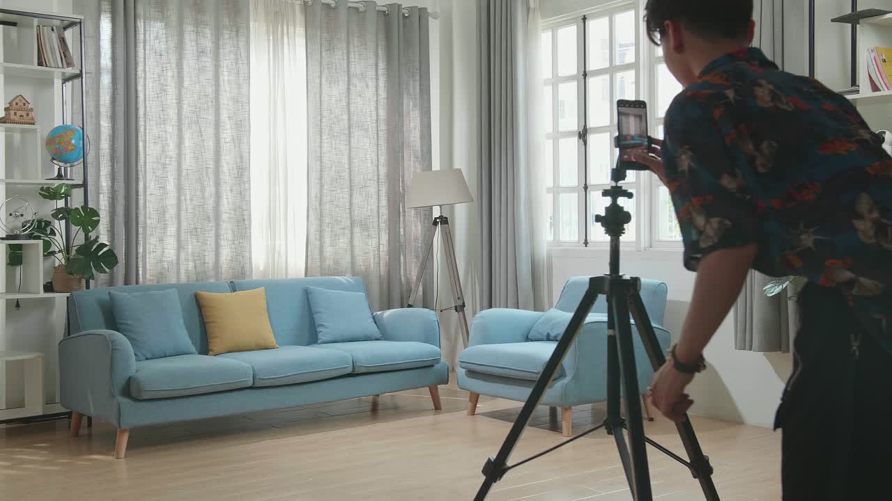 Man vlogging in a living room