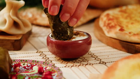 preparing dolma with yogurt sauce and adjarian khachapuri