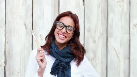 Smiling-hipster-woman-holding-paintbrush