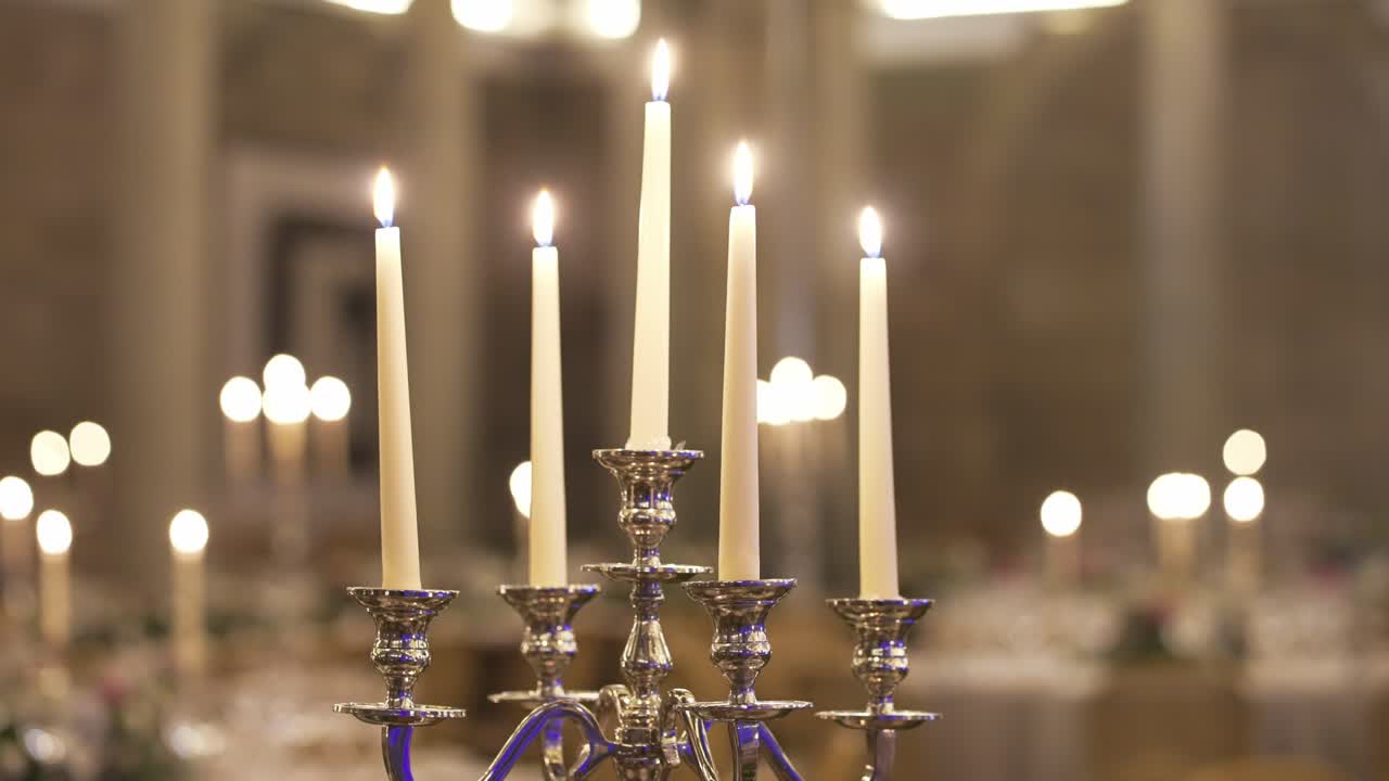 Candelabra with lit candles creating a warm, elegant ambiance in a softly lit room